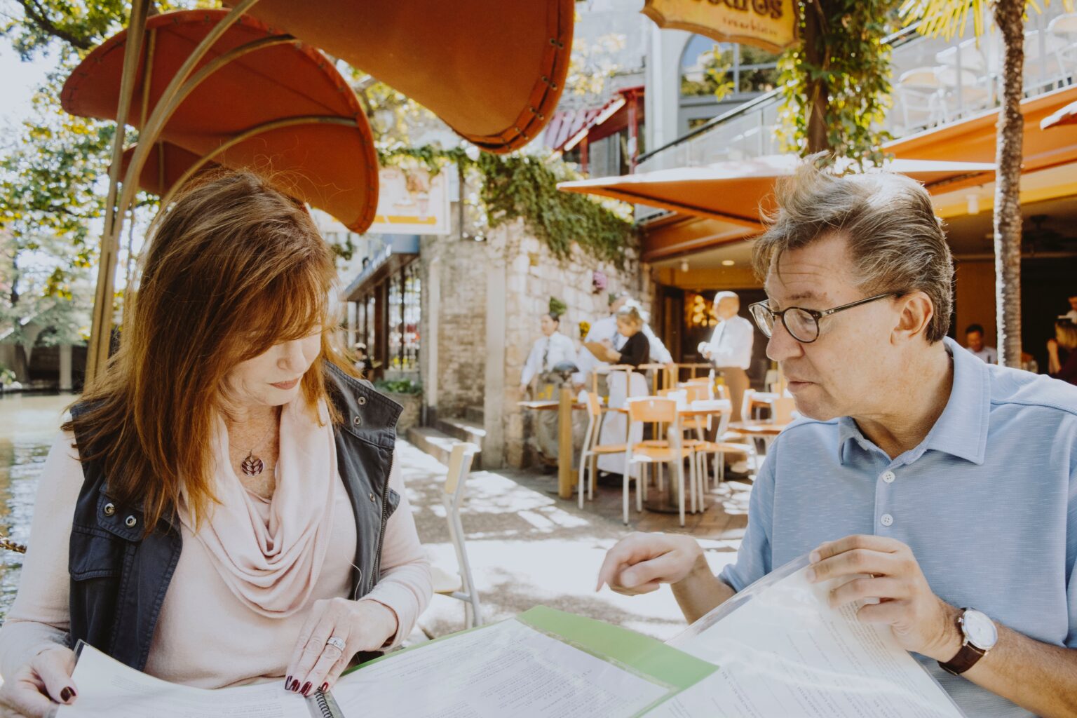 Middle-Aged Couple Looking at Menus at a Restaurant